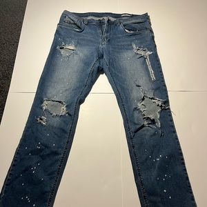 Blue ripped jeans paint splatter